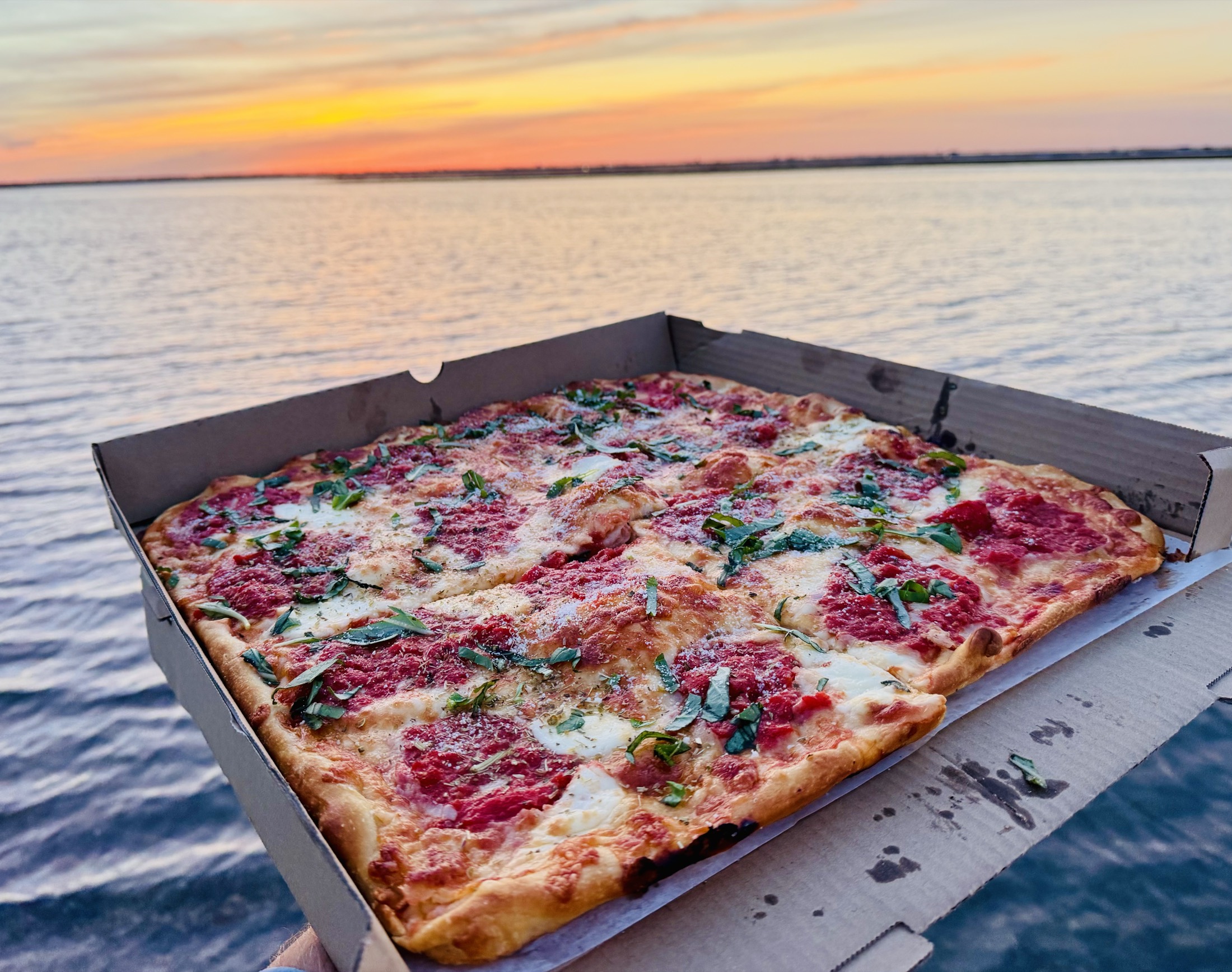 Zorro's Grandma pizza beside the Ventnor shore at sunset